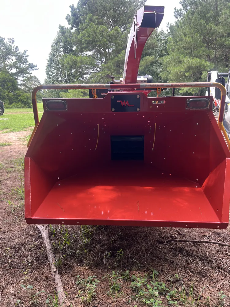 Wide red Morbark chipper feed hopper and discharge chute