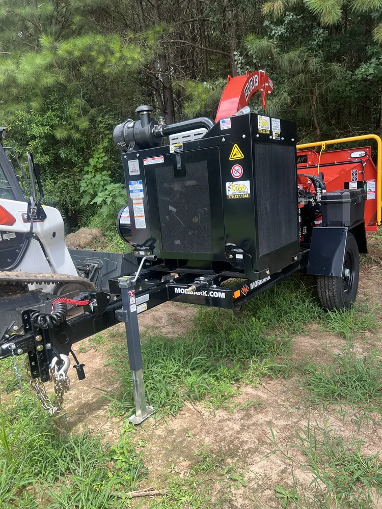 Towable Morbark chipper beside loading equipment